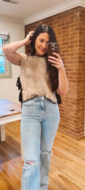 brown sleeveless sweater with bow