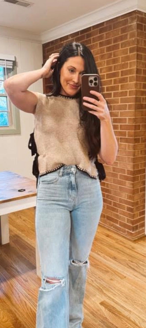 brown sleeveless sweater with bow